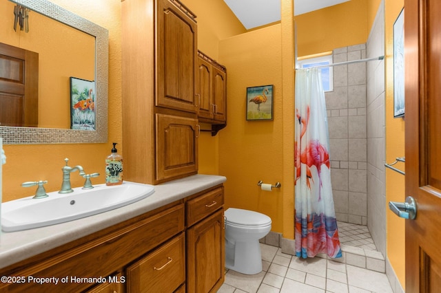 bathroom featuring toilet, a shower stall, tile patterned flooring, and vanity