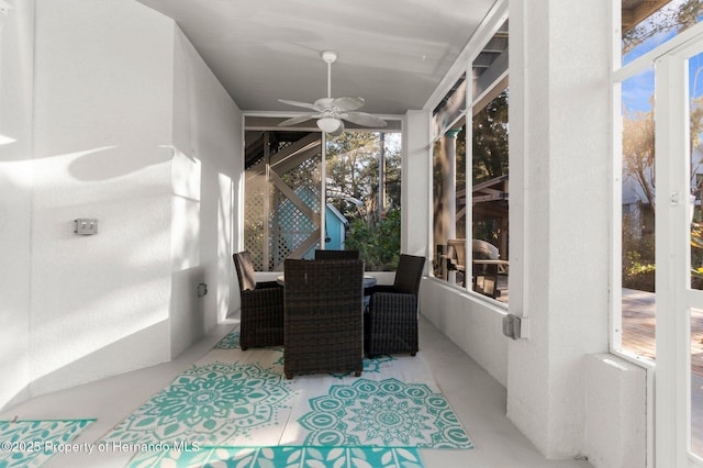 sunroom with a ceiling fan