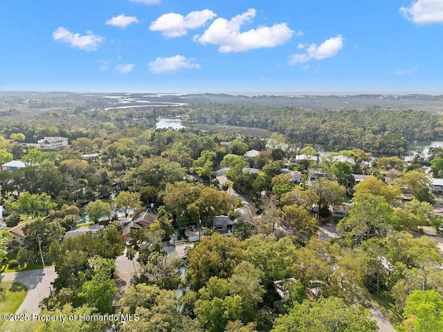 birds eye view of property featuring a wooded view