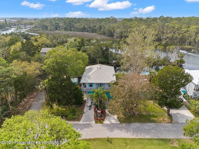 aerial view with a water view and a wooded view