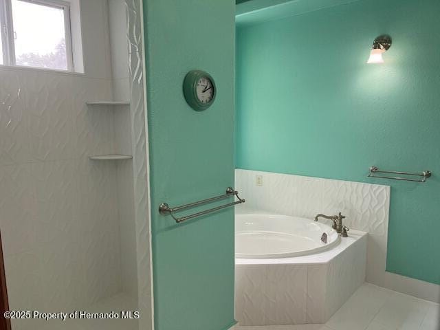 full bathroom featuring a garden tub, walk in shower, and tile patterned floors