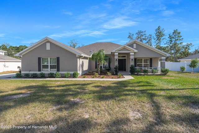 view of front of property featuring fence, a front lawn, a porch, and stucco siding