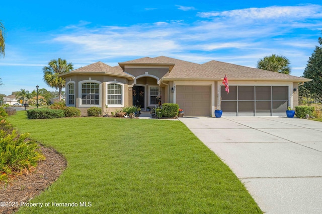 view of front of property featuring a garage, stucco siding, concrete driveway, and a front yard