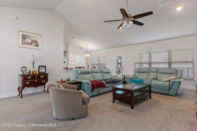 living area with light colored carpet, visible vents, high vaulted ceiling, baseboards, and ceiling fan with notable chandelier