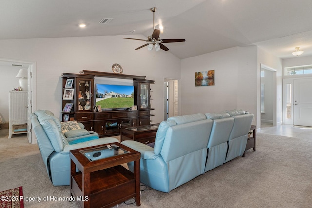 living room featuring a ceiling fan, light colored carpet, vaulted ceiling, and visible vents