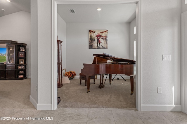 living area featuring light carpet, visible vents, and baseboards