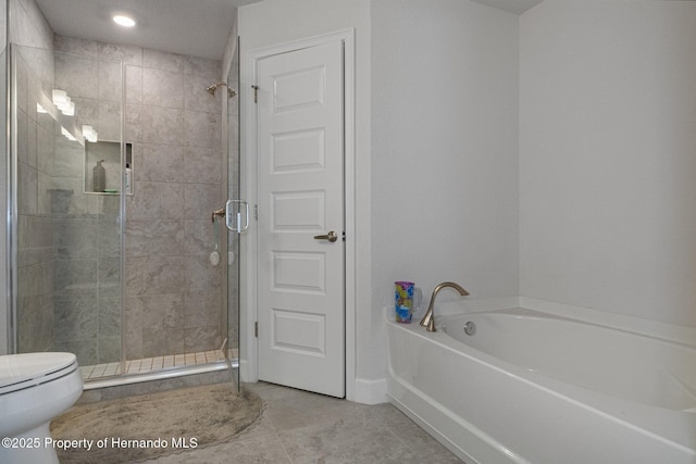 full bathroom featuring a stall shower, tile patterned flooring, a garden tub, and toilet