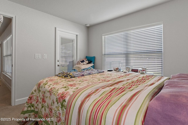 bedroom featuring carpet flooring and baseboards