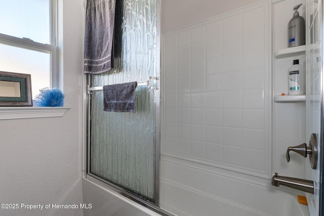 bathroom with shower / bath combination with glass door