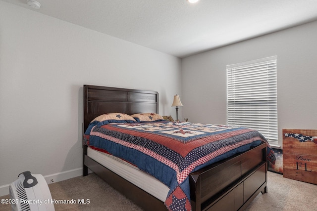 bedroom with light carpet and baseboards