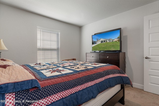 bedroom with carpet and baseboards