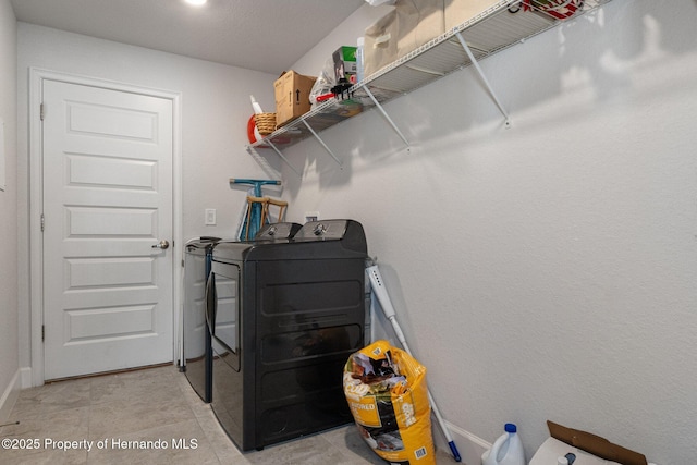 laundry room with light tile patterned floors, laundry area, and washer and dryer