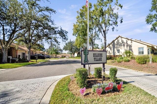 view of road with a residential view and curbs