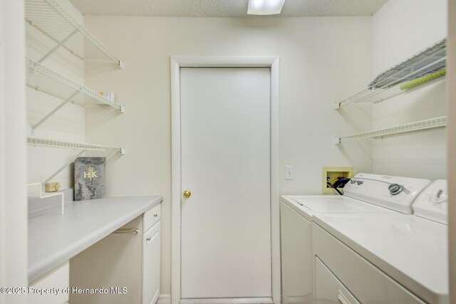 clothes washing area featuring laundry area, washer and clothes dryer, and a textured ceiling