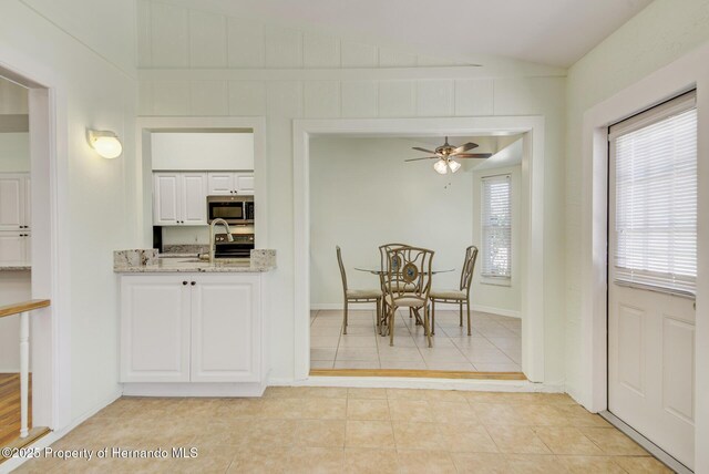 dining room featuring vaulted ceiling, ceiling fan, and light tile patterned floors