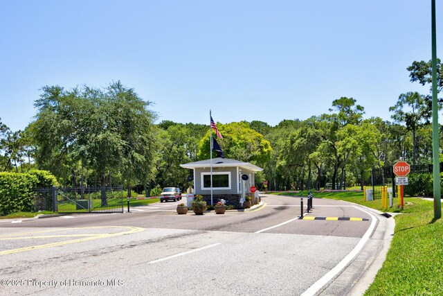 view of road featuring traffic signs and curbs