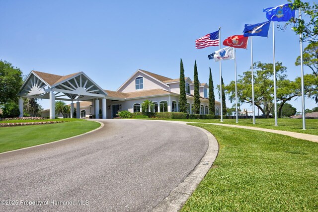 exterior space with driveway and a front yard