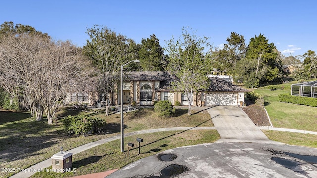 view of front of house with a garage, driveway, and a front lawn