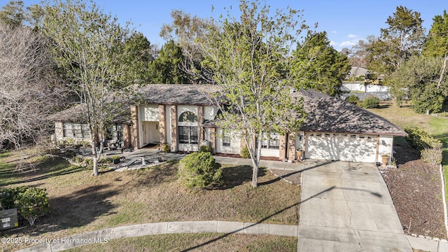 tudor house with an attached garage and driveway