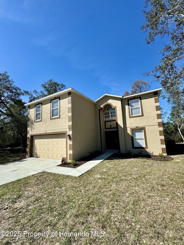 view of front facade featuring a garage, driveway, a front lawn, and stucco siding