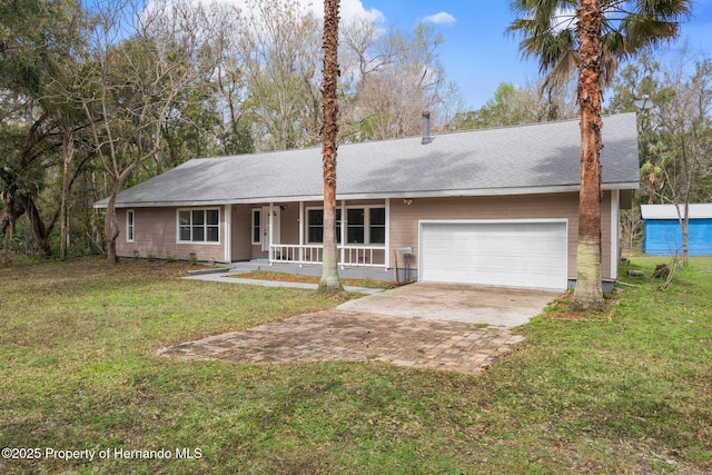 ranch-style house with driveway, covered porch, a garage, and a front lawn