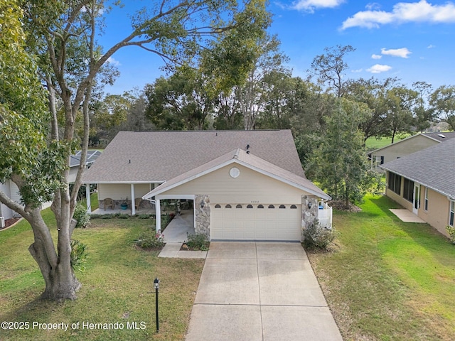 view of front of house featuring a garage, a shingled roof, a front lawn, and concrete driveway