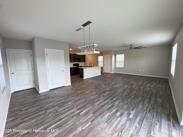 kitchen with a wealth of natural light, open floor plan, visible vents, and hanging light fixtures