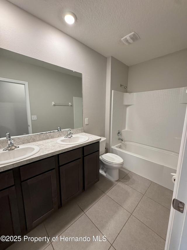 full bath featuring washtub / shower combination, a sink, visible vents, and tile patterned floors