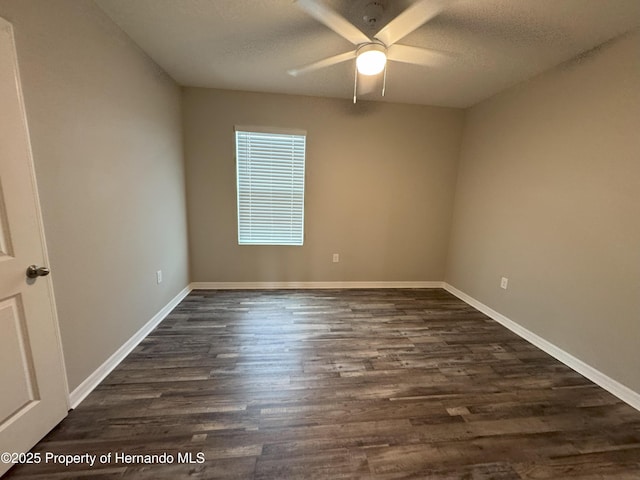 unfurnished room with dark wood-style floors, a textured ceiling, baseboards, and a ceiling fan