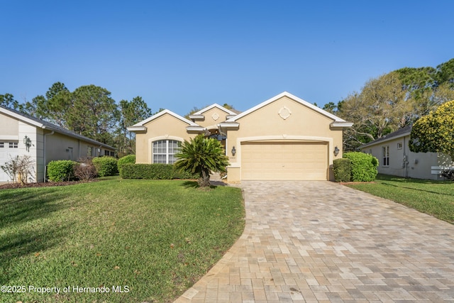 ranch-style home featuring stucco siding, decorative driveway, a garage, and a front yard