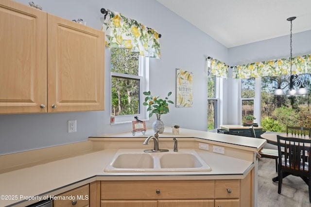 kitchen featuring a sink, a notable chandelier, light brown cabinets, and light countertops