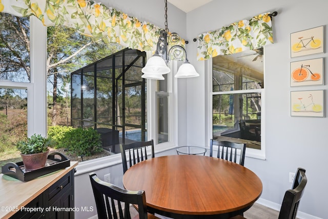 dining room featuring baseboards and wood finished floors