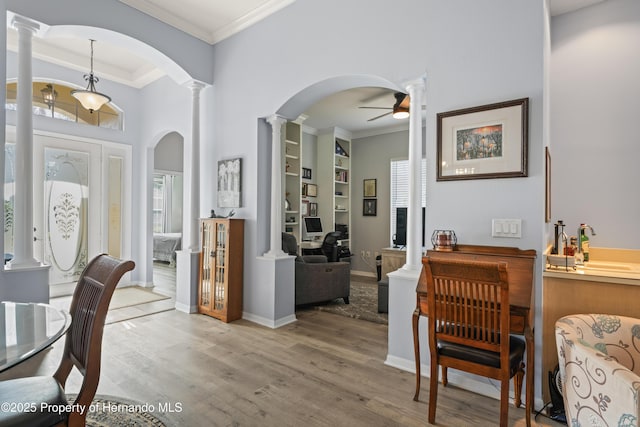 entrance foyer featuring ornamental molding, a wealth of natural light, and ceiling fan