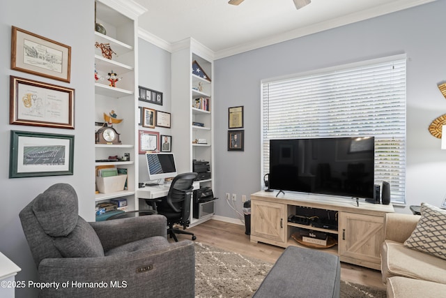 office with built in features, baseboards, light wood finished floors, ceiling fan, and crown molding