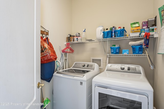 laundry area featuring washer and clothes dryer and laundry area