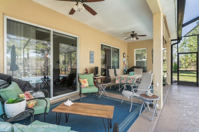 sunroom with a ceiling fan