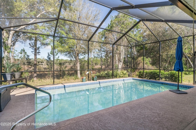 outdoor pool with a lanai and a patio area