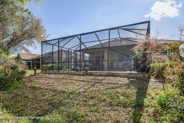 back of property with a lanai