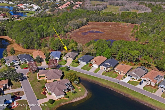 drone / aerial view with a residential view and a water view