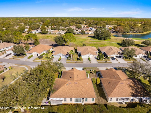 drone / aerial view with a water view and a residential view