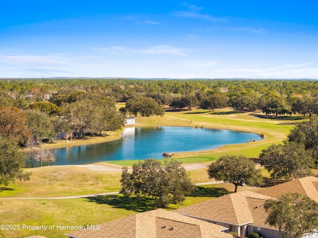 bird's eye view with view of golf course, a water view, and a view of trees