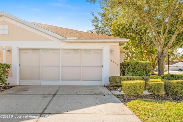 garage with concrete driveway