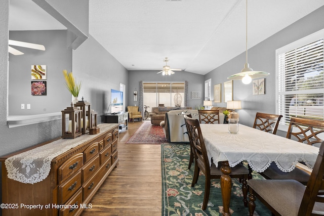 dining space with a ceiling fan and dark wood-type flooring