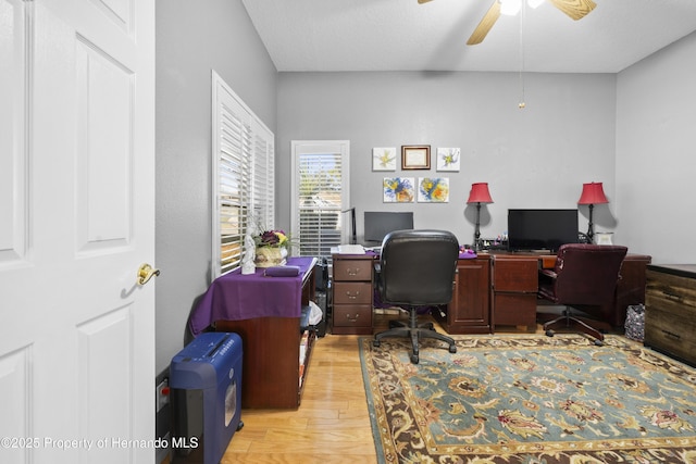 home office featuring light wood finished floors and a ceiling fan