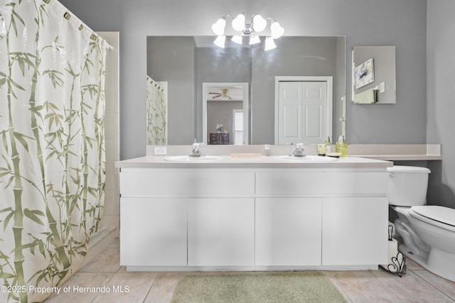 full bath featuring double vanity, a closet, a sink, and tile patterned floors