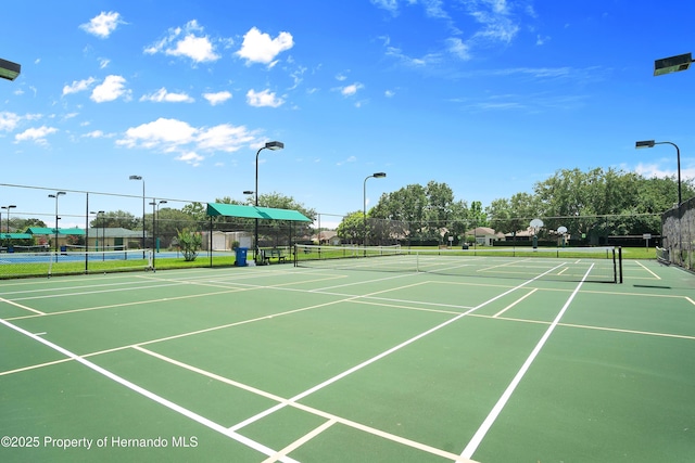 view of sport court featuring fence