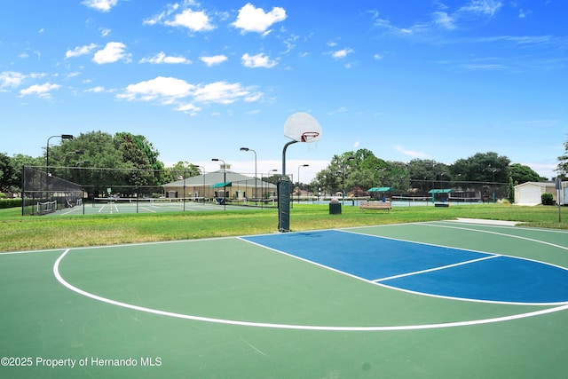 view of sport court featuring community basketball court, a tennis court, and fence