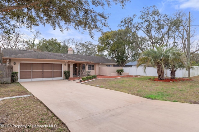 ranch-style home featuring fence, an attached garage, and stucco siding