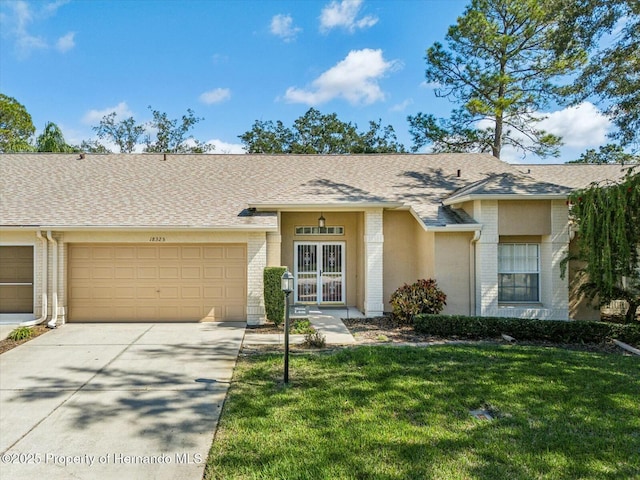 view of front of house with driveway, a front yard, and brick siding