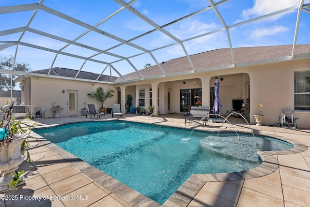 outdoor pool featuring a patio area and glass enclosure